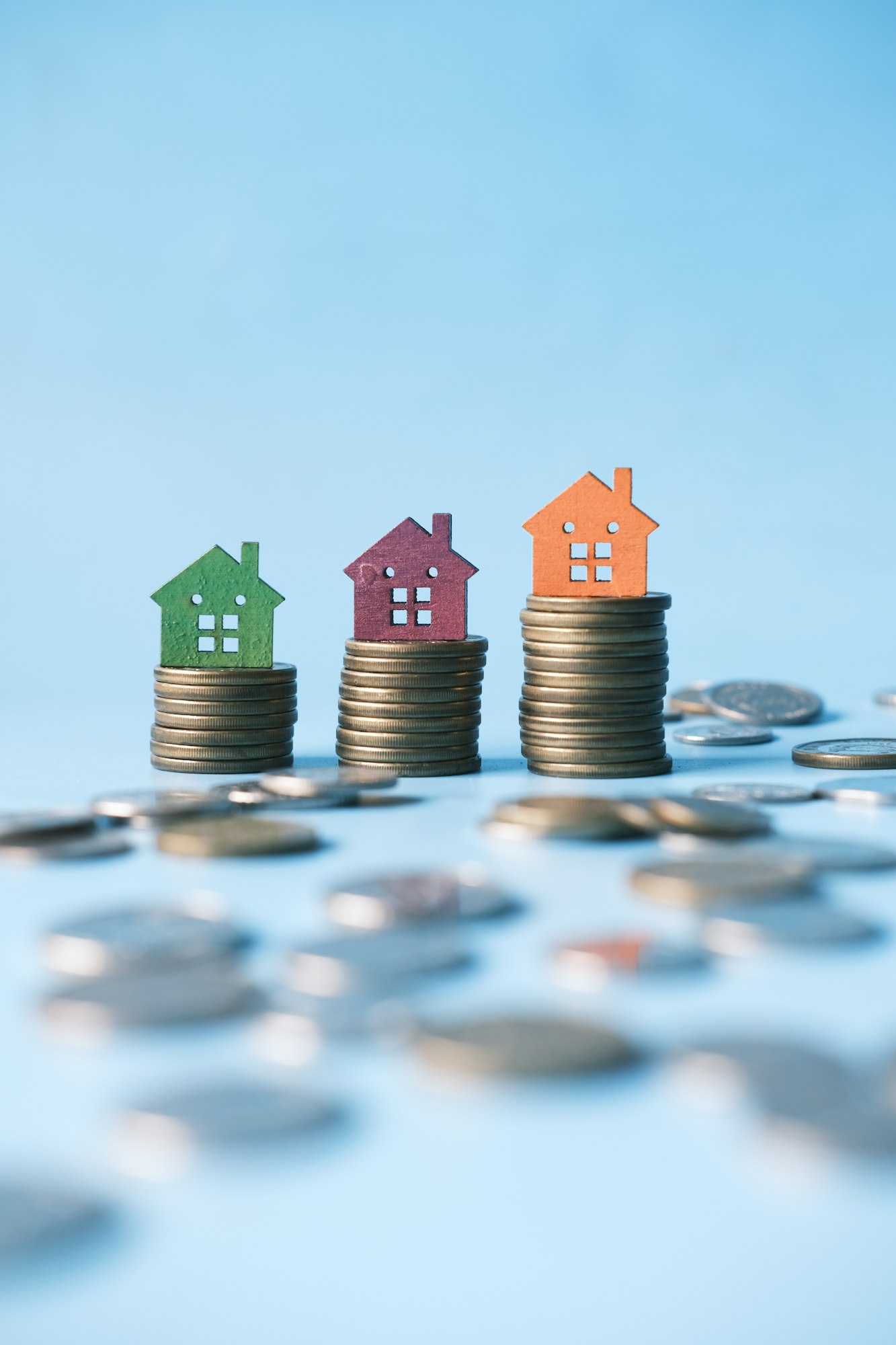 stack of coins and house on table , the concept of house finance